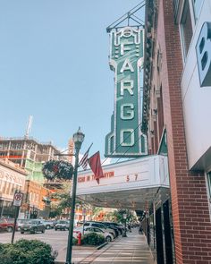 the marquee sign is hanging from the side of the building on the street