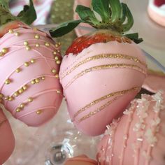 three chocolate covered strawberries with gold sprinkles