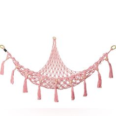 a pink netted hammock with tassels hanging from it's sides