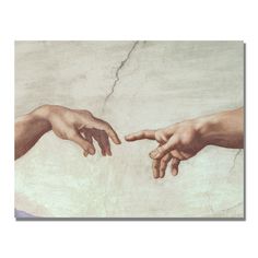 two hands touching each other in front of a painting