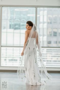 a woman in a white wedding dress and veil