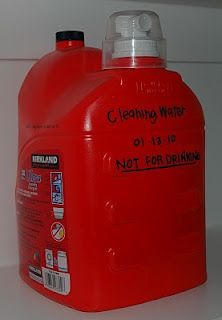 a red plastic jug sitting on top of a counter