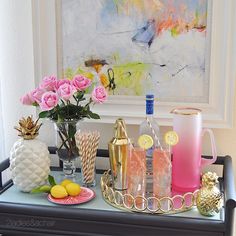 a table topped with pink roses and drinks