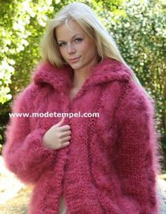 a woman is wearing a pink fuzzy coat