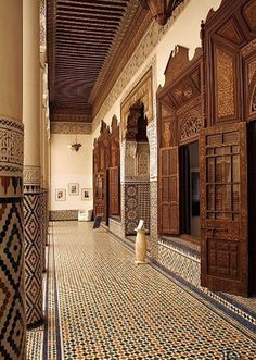 an ornately decorated hallway with wooden doors and windows