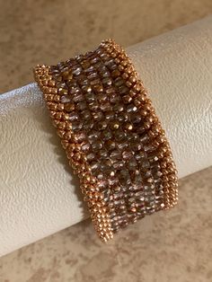 This is a one of kind, Czech fine polish cuff handcrafted with a copper slide clasp. Elegant Brown Cuff Bracelet As Gift, Elegant Brown Cuff Bracelet Gift, Elegant Handmade Copper Bracelets, Handmade Rose Gold Copper Cuff Bracelet, Unique Gold Beaded Cuff Bracelet, Elegant Handmade Copper Cuff Bracelet, Elegant Silver-colored Copper Cuff Bracelet, Elegant Hand Wrapped Copper Bangle, Elegant Adjustable Bronze Cuff Bracelet