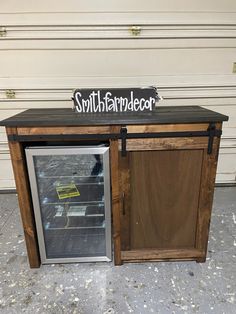 a small refrigerator with the door open and a sign that says, south farmader