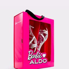 a pink barbie doll shoe box with its lid open and two pairs of shoes in it