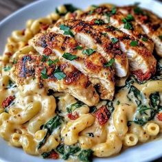 a white plate topped with pasta and chicken