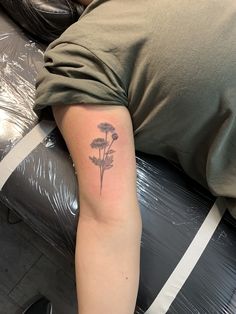 a person with a flower tattoo on their arm