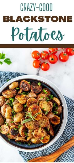 a white bowl filled with potatoes on top of a blue and white table cloth next to tomatoes