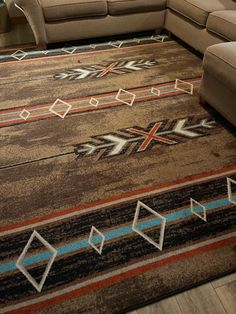 a living room with a couch and rug on the floor