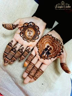 two hands with henna designs on them, one is showing the bride and groom