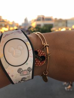 a close up of a person's wrist with two bracelets on top of it