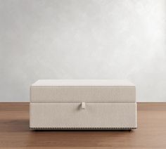 a white box sitting on top of a wooden floor