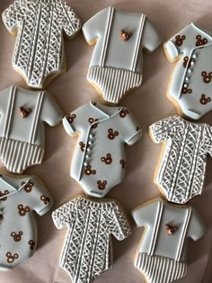 decorated cookies in the shape of baby's bodysuits and onesuits