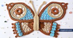 crocheted butterfly made with yarn and thread in blue, brown and white colors