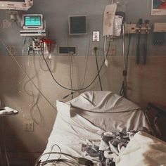 a hospital room with multiple monitors and medical equipment on the wall, including an oxygen tube