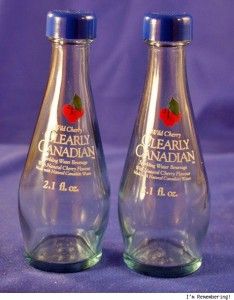 two empty glass bottles sitting next to each other on a blue cloth covered tablecloth