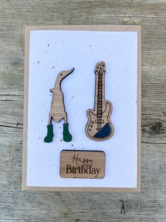 a birthday card with an image of a guitar and a dog on it, which says happy birthday