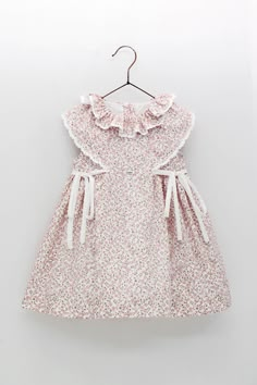 Brand: Foque Reference: 2415945 Color: Light Pink Composition: 100% cotton. Lining is 78% polyester, 22% cotton. Intended Age: Baby Girl, Toddler Girl Description: The dress is made in lightweight cotton. The frilled sleeves and collar have embroidered trims for a sweet finish. The gathered skirt has fixed bows on the front for a pretty look. Fully lined, it fastens with pink pearlescent buttons on the back for a neat finish. Size chart: Small fitting brand for the smaller sizes. True to size in Girls Summer Dress Pattern, Frilled Sleeves, Kids Party Wear, Baby Girl Toddler, Summer Dress Patterns, Baby Dress Design, Baby Frocks Designs, Girl Toddler, Antique Clothing