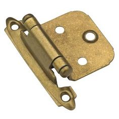 an antique brass plated door hinge with two holes