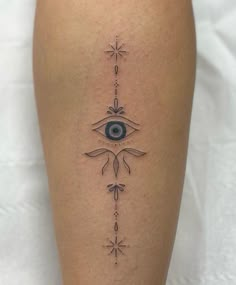 a woman's leg with an all seeing eye tattoo on the side of her thigh