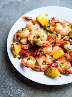 a white plate topped with shrimp and veggies