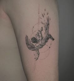 a tattoo on the arm of a person with a bird flying through it's body