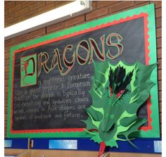 a sign that says dragon's on the side of a building with green leaves