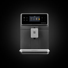 an espresso machine is shown on a black background