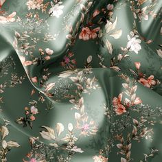 a green floral print fabric with pink and white flowers on the top, as well as dark green background