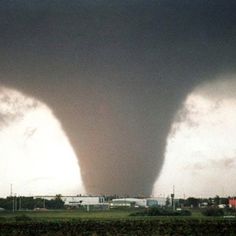 a large tornado is seen in the sky