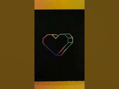 a heart is drawn on the side of a black piece of paper with colored lines