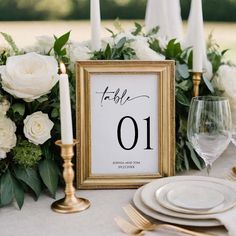 a table with white flowers, candles and a framed sign that says it's 10