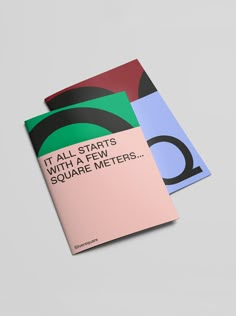 two booklets with different colors and shapes on them, one is pink, the other is blue