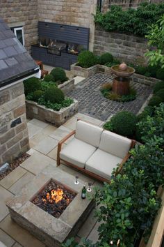 an outdoor patio with seating and fire pit