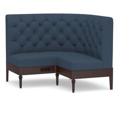 the corner couch is made from wood and has blue upholstered fabric on it