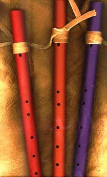 three recorders tied together with twine and string