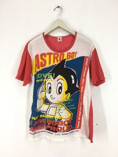 "Vintage 80s 90s Astroboy Japanese Anime t shirt Made in Japan SIZE : Fit like L (PLEASE CHECK THE MEASUREMENT BELLOW) ARMPIT TO ARMPIT : 19\" LENGHT : 25\" CONDITION : faded condition and distressed at neck refer photos (6/10) MATERIAL : 100% cotton SHIPPING : I will be ship after received a payment and give tracking numbers. After 7 - 14 Working Days of Shipping from Malaysia please check & give your tracking number parcel to your national post. Receiving the parcel within 7-14 working day 90s Anime Print Crew Neck Top, 90s Style Cotton T-shirt With Retro Print, 80s Japanese Fashion, 90s Anime Print Short Sleeve T-shirt, 90s Cotton T-shirt With Retro Print, 90s Cotton Graphic T-shirt, Style Bundle, Anime T Shirt, Astro Boy