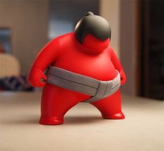 a red toy with a belt around it's waist