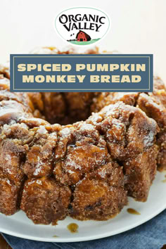 a spiced pumpkin monkey bread on a white plate with the title above it that reads, organic valley