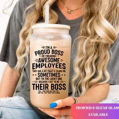 a woman sitting on a couch holding a drink with the words i'm a proud boss