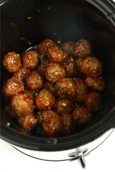 the meatballs are being cooked in the crock pot for dinner or appetizer