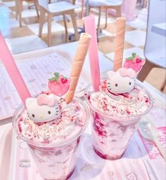 two hello kitty ice cream sundaes with strawberries on top