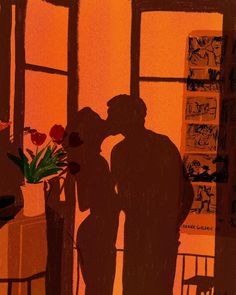 two people are kissing in front of a window