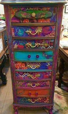 an old dresser has been painted with colorful paint