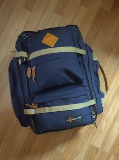 a blue backpack sitting on top of a wooden floor