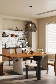 a dining room table and chairs in front of a window