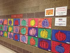 the wall is decorated with many different colored pumpkins and other items on it's sides